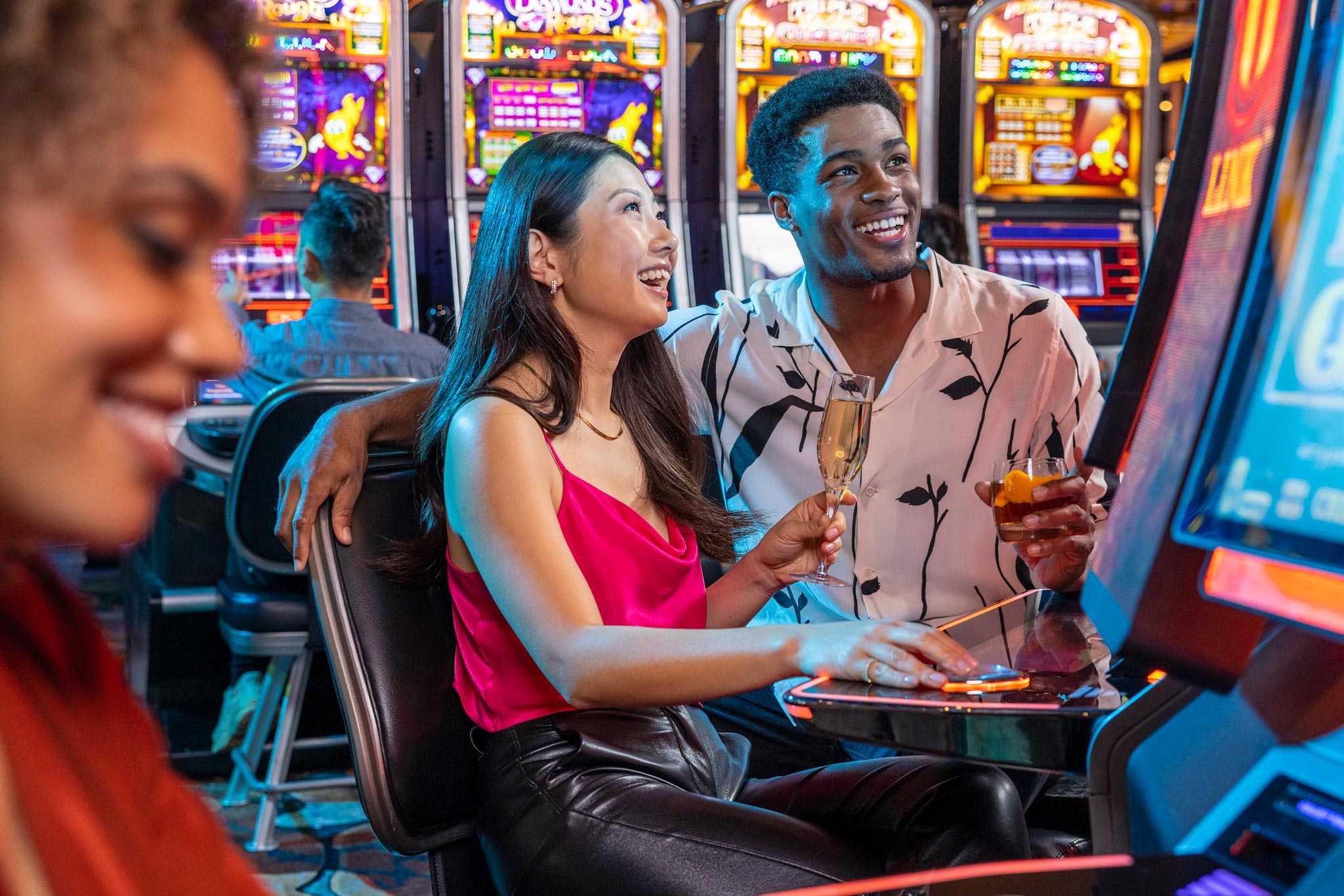 A couple having a good time playing slot machines in San Diego's Jamul Casino.