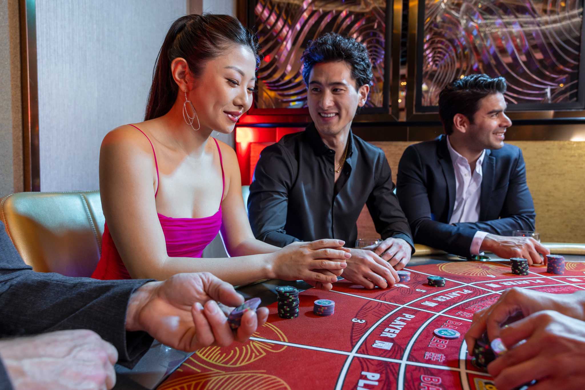 Young people having a good time playing table games in San Diego's Jamul Casino.