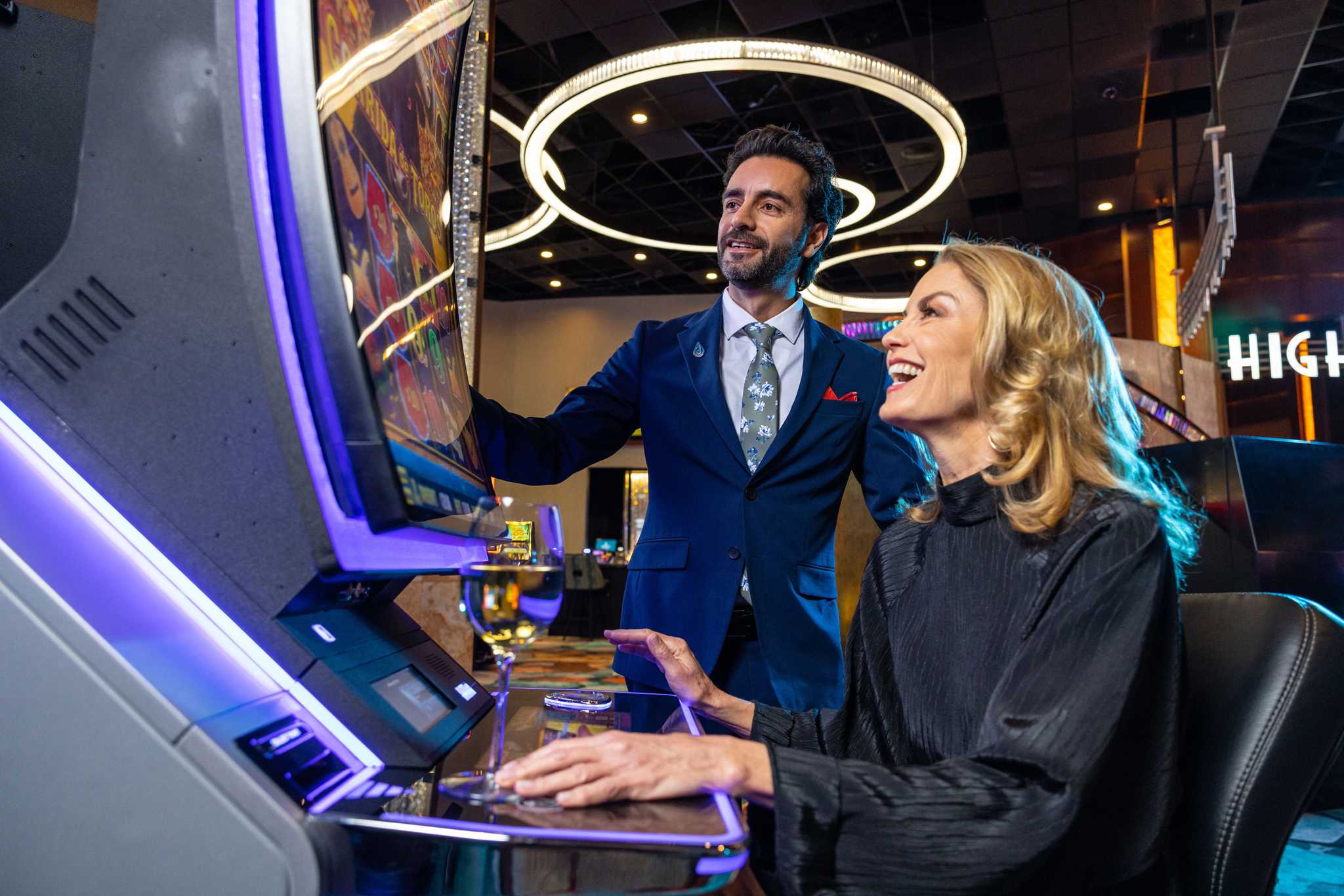 A guest enjoying slot machines while getting the VIP casino host experience in San Diego.